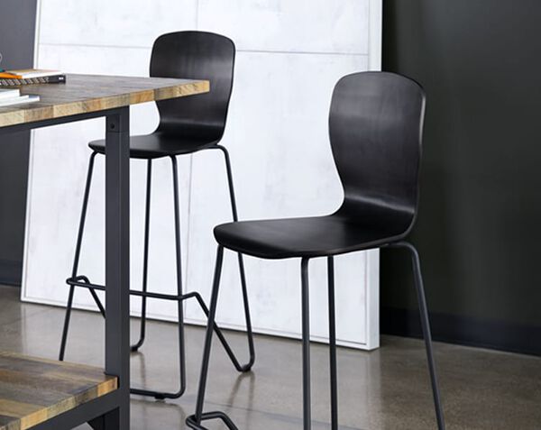 two chairs shown next to standing height conference table in office
