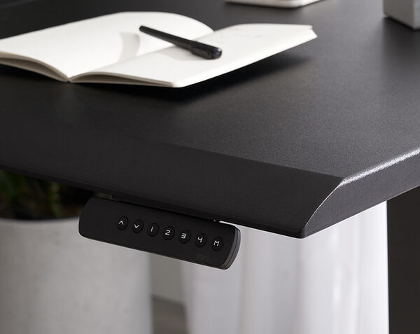 Close up view of the edge of the l shape electric standing desk