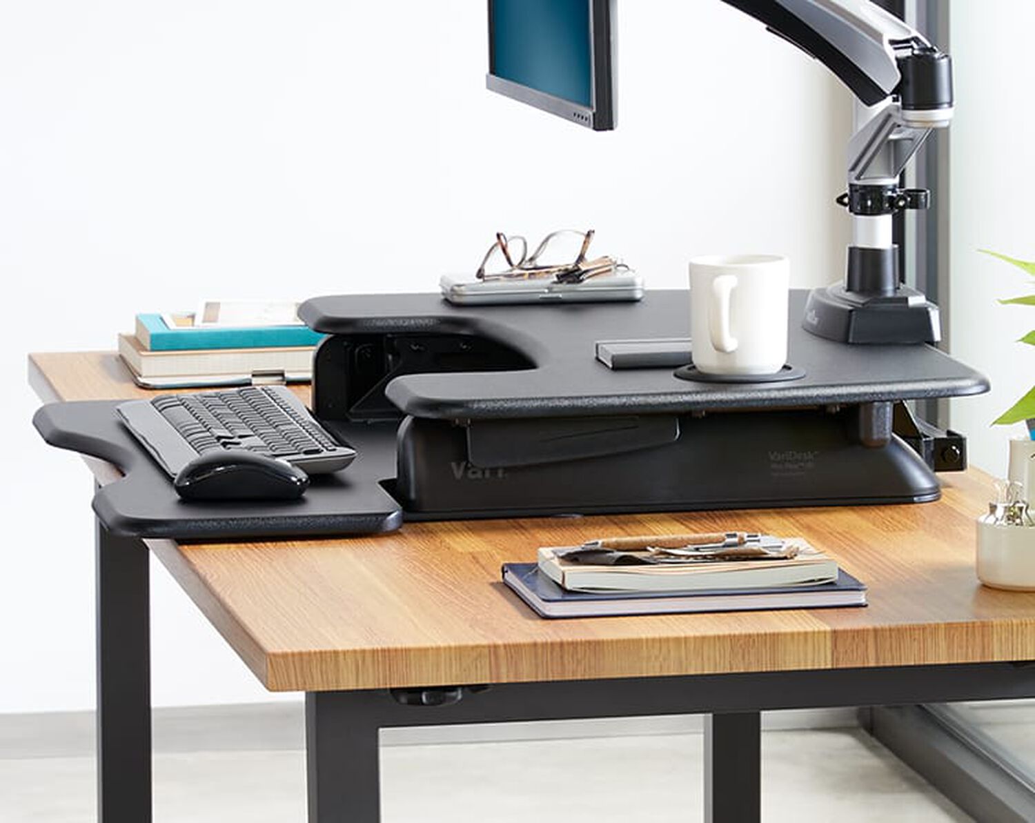 Overhead view of desk riser on static height desk in office setting