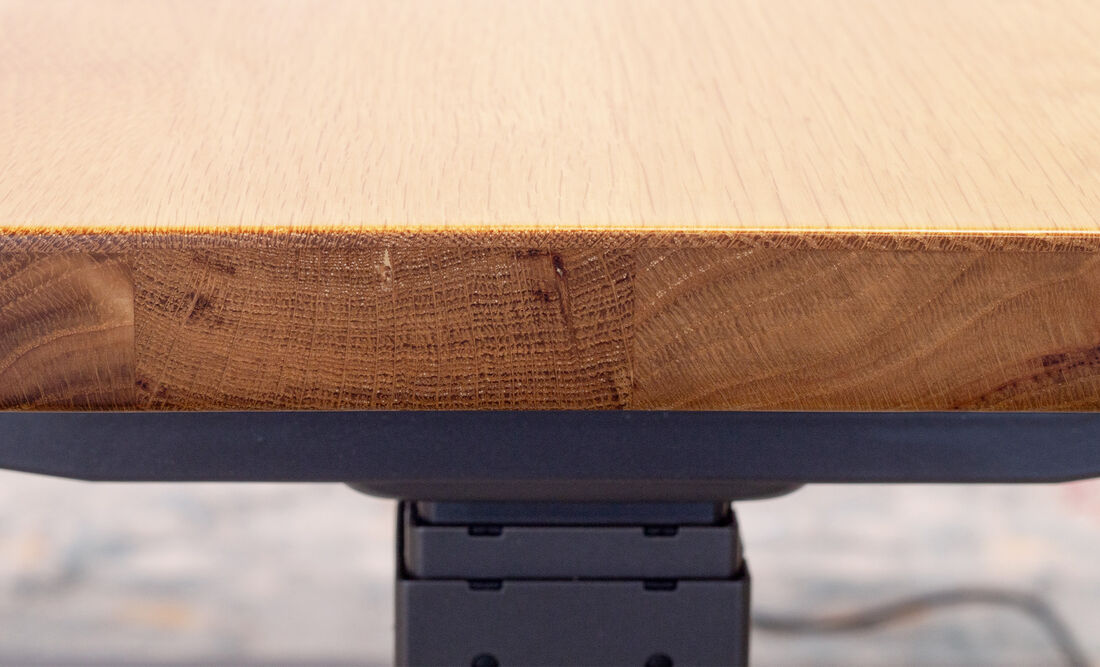 zoomed in look of solid wood desk with leg