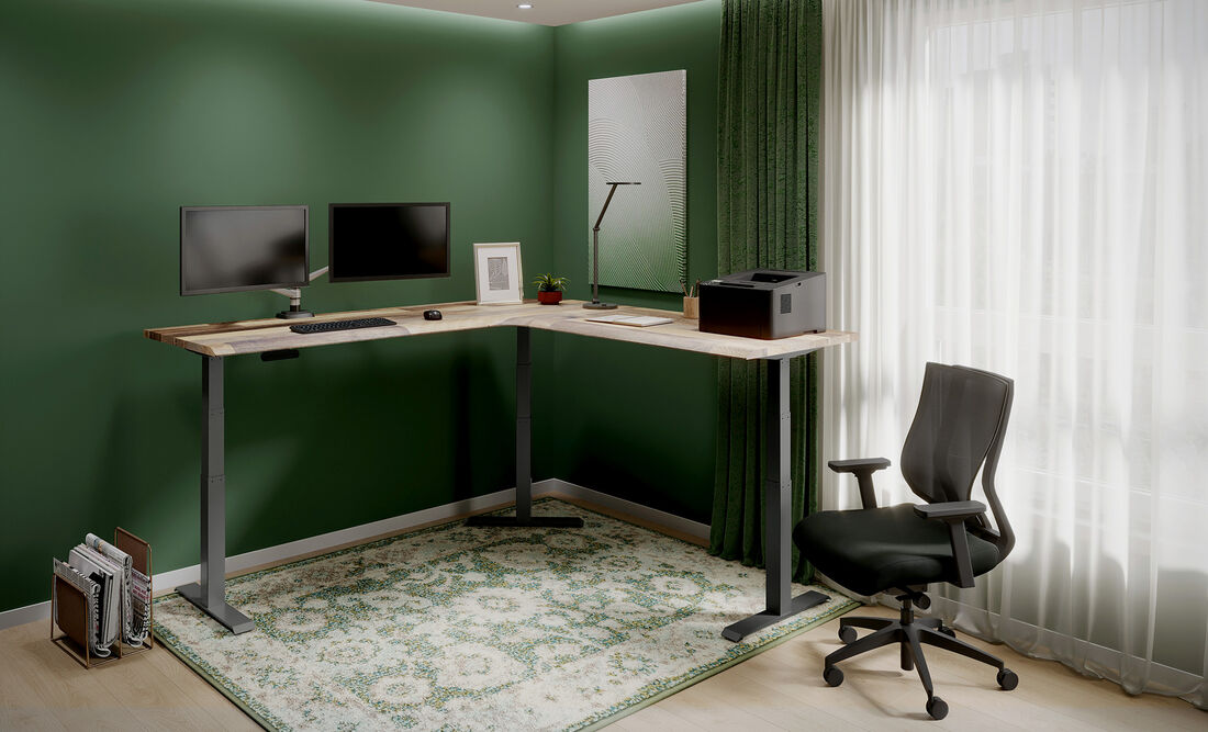 L-Shape electric standing desk setup in the corner of an open workspace