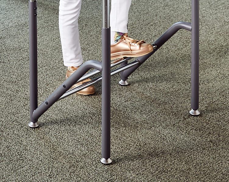 student rests one foot on rung while standing with other foot