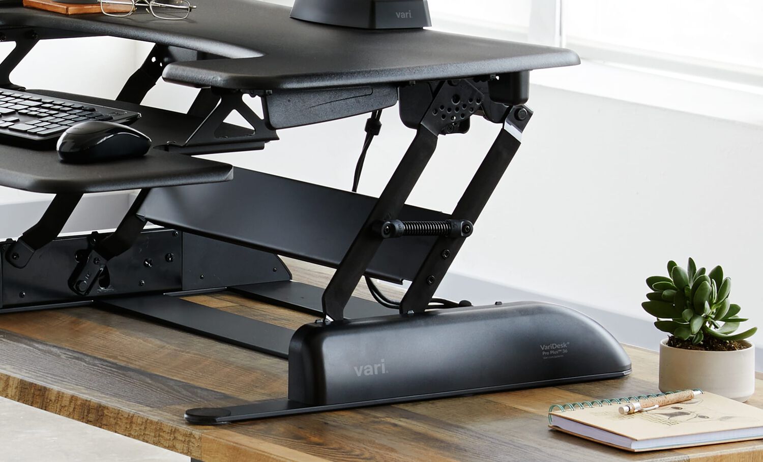 Converter is raised in an office setting to show the spring-assisted lift