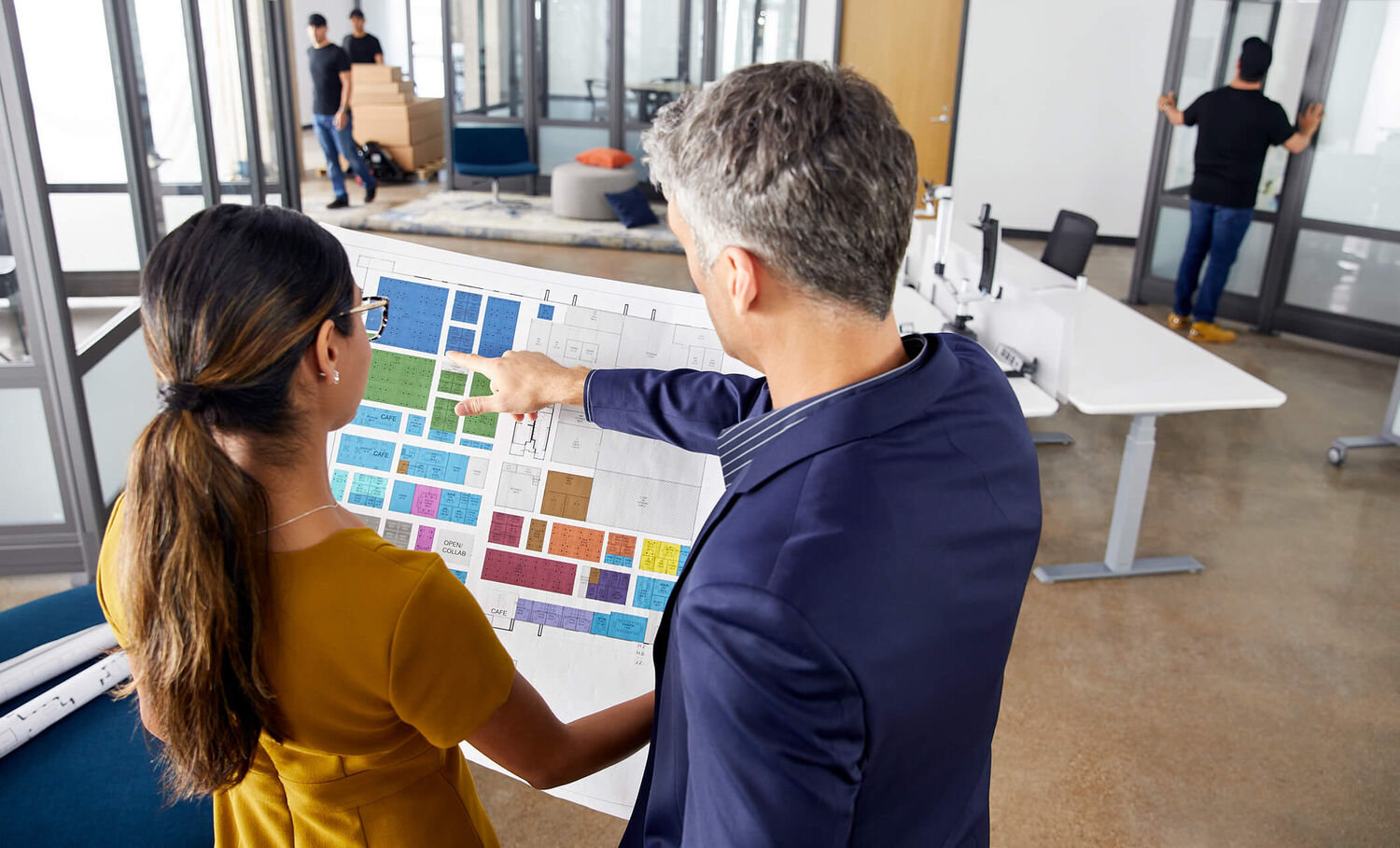 people reviewing a space plan in an office undergoing a furniture design project