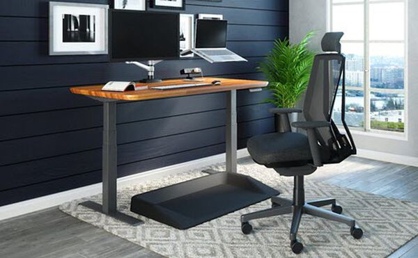 electric standing desk and vari accessories fill out a home office