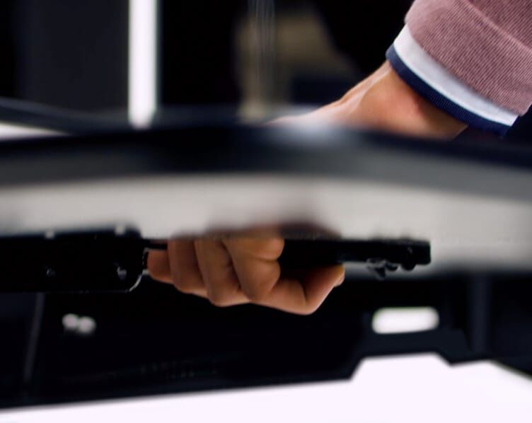 professional engages lever handle, as seen from below