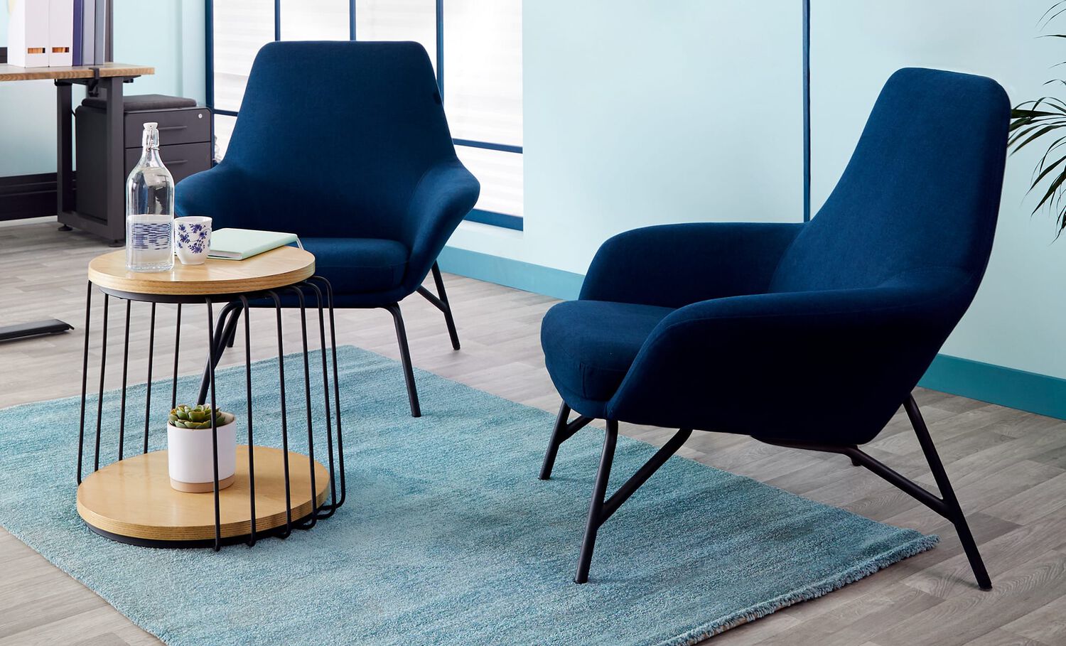 round side table and 2 arm chairs create a lounge area