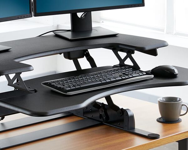 Converter raised on desk in office, keyboard tray holds mouse and keyboard