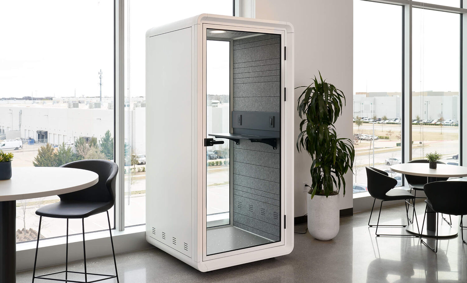 professional talking on the phone inside a privacy booth