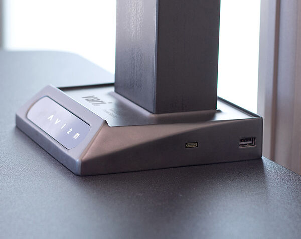 close up of the premier electric converter in walnut finish with a laptop screen and phone propped up and in use