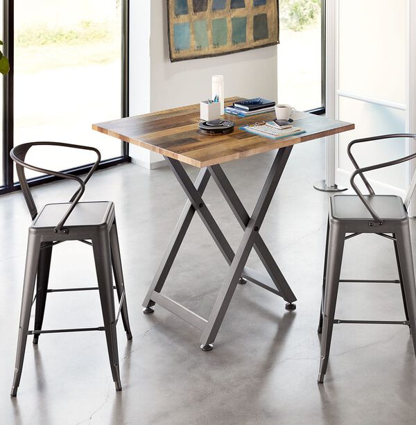 standing meeting table with tall metal chairs around it