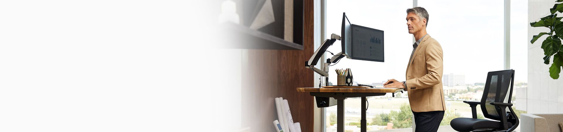 Individual working in private office at electric standing desk