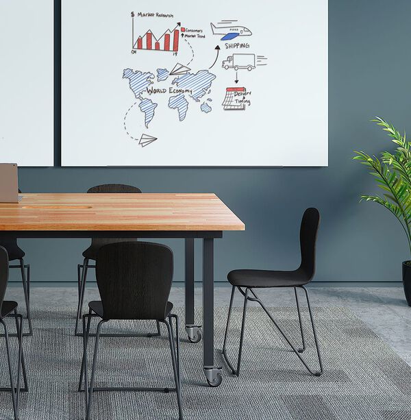 meeting room with a table, chairs and a whiteboard hanging on the wall
