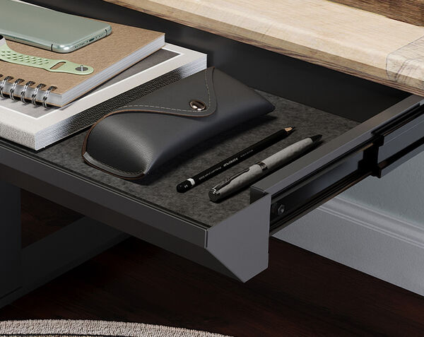 vari desk drawer pulled out from under a desk displaying the PET felt lining holding accessories in place