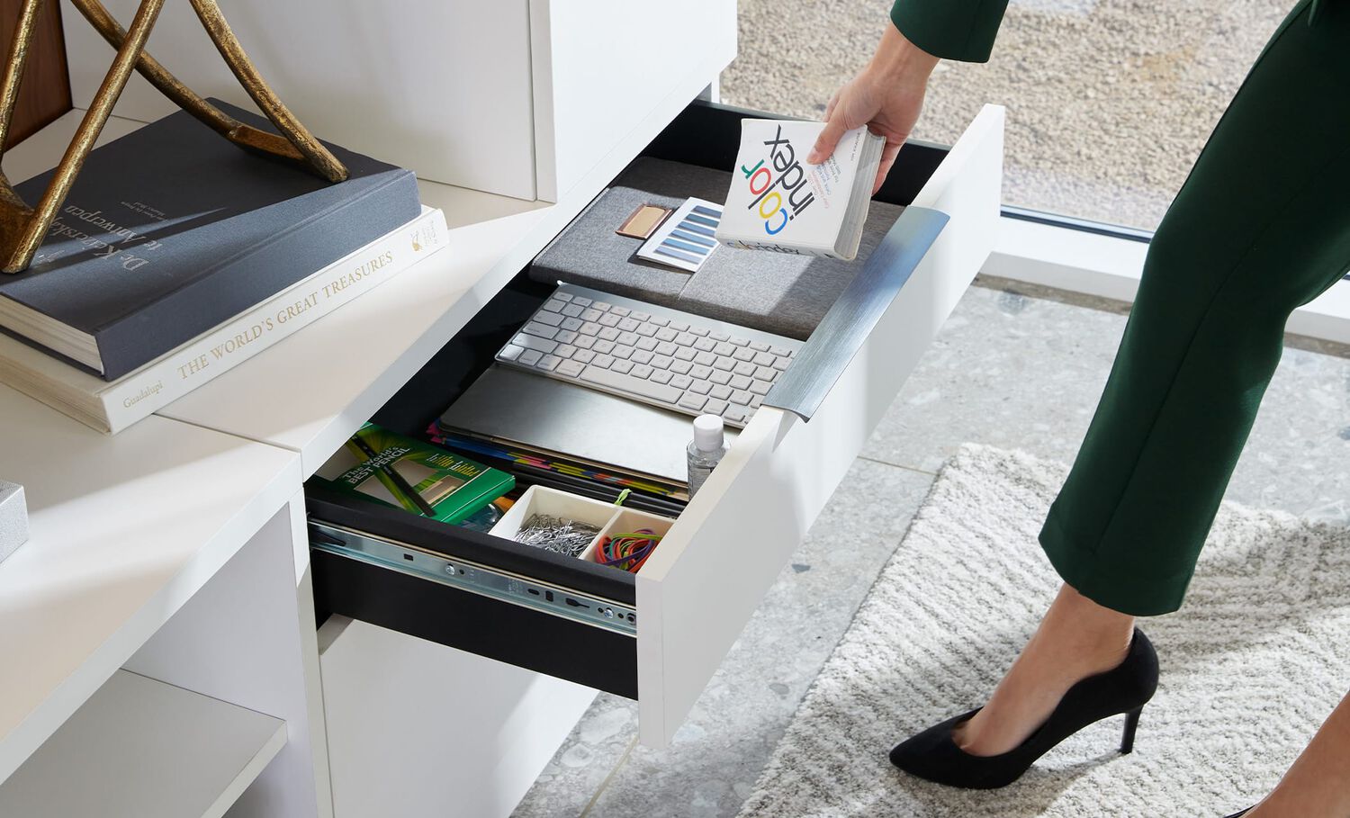 professional placing book into lateral cabinet. part of executive collection