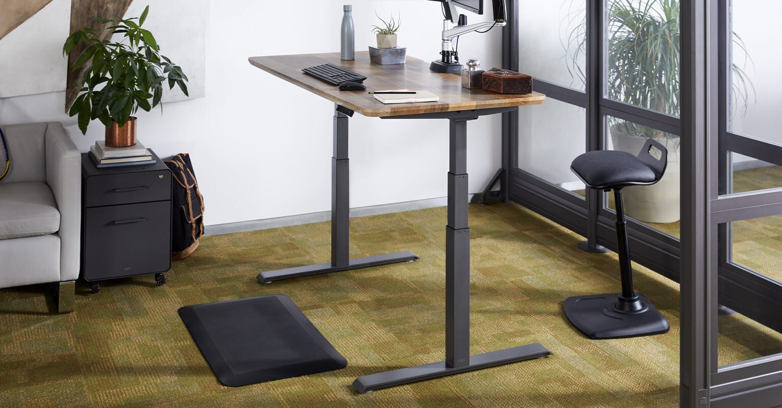 vari electric standing desk in a workspace setting