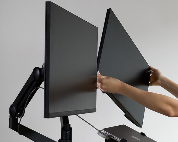 individual adjusting the monitor screen