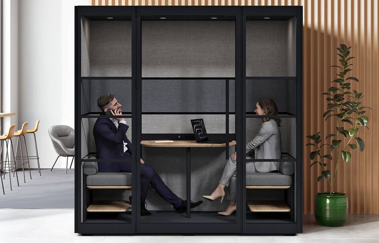 two professionals sitting in the privacy booth