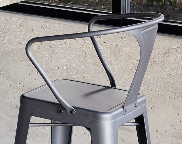 back of chair seen with bolts the attach it to the main frame