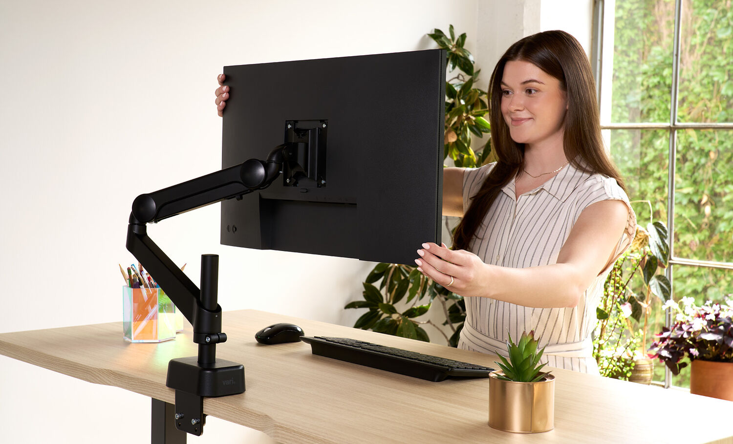 Individual in office using single monitor arm