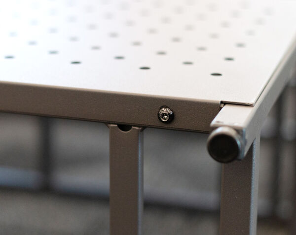 close up view of the screw that secures into the five tier open shelf for the back panel to be installed