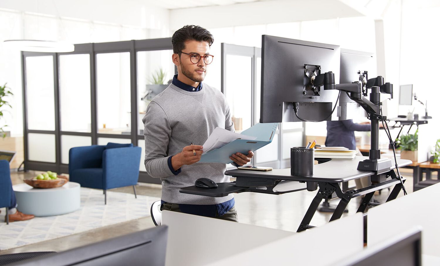 Individual using desk converter and Vari Dual Monitor arm 180 degree