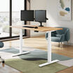 solid wood electric standing desk with a white oak top with white legs in an open home office in raised position