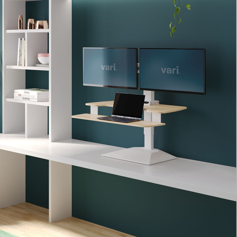 varidesk electric dual monitor converter in light wood in a raised position on desk  image number null