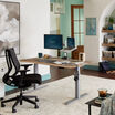Electric Standing Desk 60x30 Butcher Block in lowered position at home