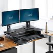 varidesk pro plus 36 black sit-stand desk converter in lowered position in office