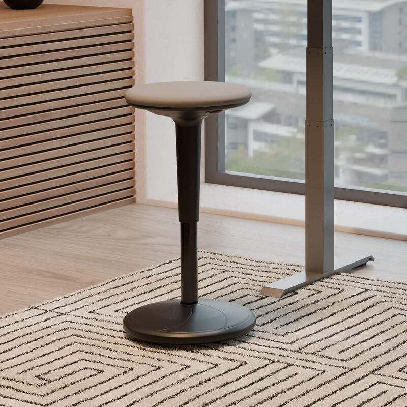 balance stool sitting in front of an electric standing desk in a office image number null