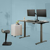 Posture perfect bundle includes an electric standing desk a dual monitor arm a file cabinet and active seat 