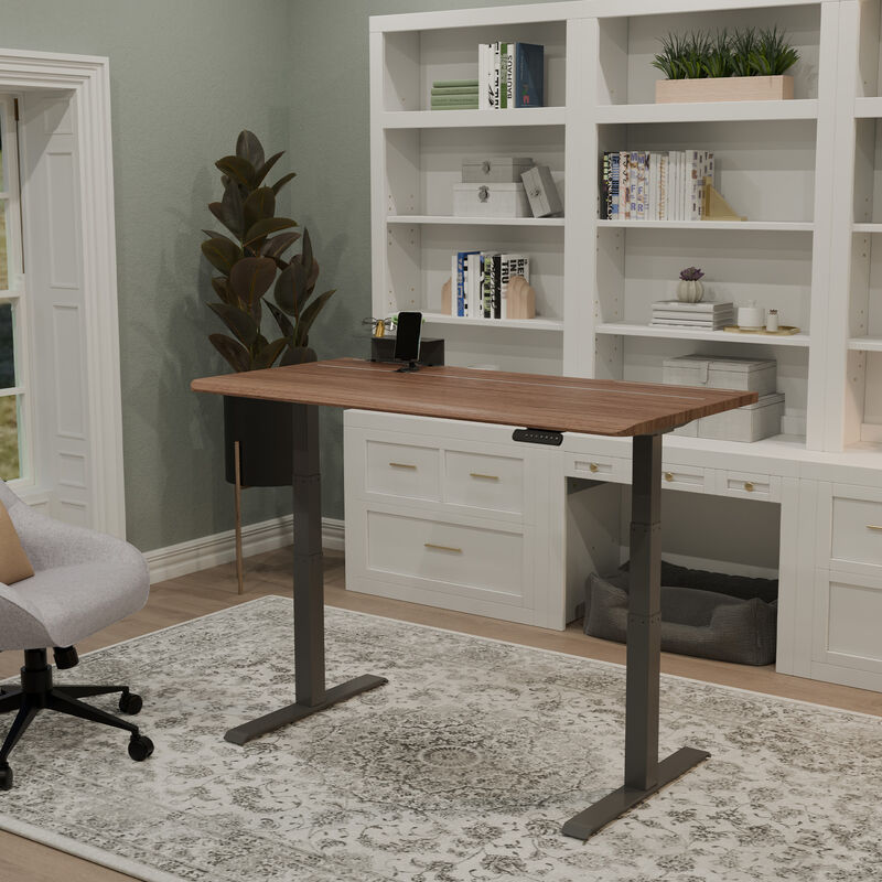 Electric Standing Desk 60x30 with tech track in walnut with slate legs in lowered position at home image number null