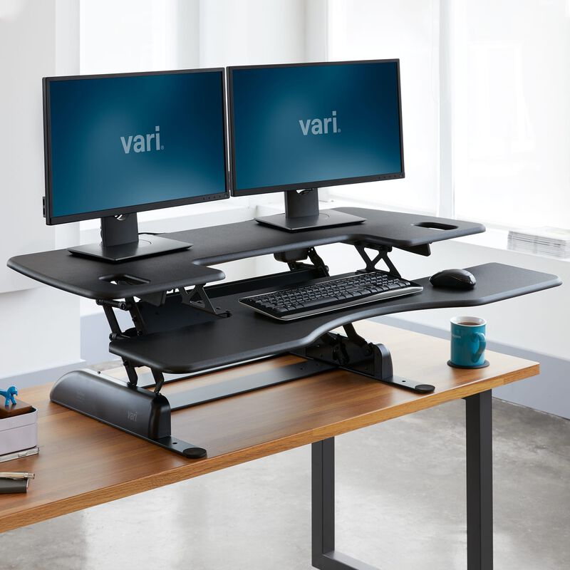 VariDesk Pro Plus 48 Black sit-stand desk converter in raised position in office  image number null