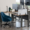 Vari Acrylic Privacy Panel 24 in Frosted Acrylic installed on an electric standing desk in an office setting 