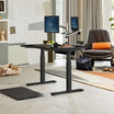 Electric Standing Desk 48x30 Black in lowered position at home 