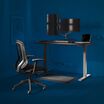 performance home office set made up of curve electric standing desk 60 by 30, performance task chair, dual monitor arm, standing mat 34 by 20, power hub, and power strip 8 foot with blue background