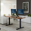 Electric Standing Desk 60x30 Walnut in raised position at home
