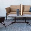 contemporary three-seat sofa in sandstone placed in office setting with the contemporary coffee table