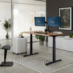Electric Standing Desk 60x30 walnut with slate legs in lowered position at home