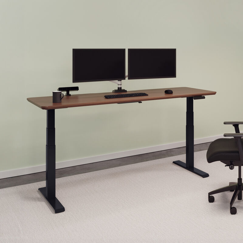 Electric standing desk 72x30 in walnut finish with black legs raised in office image number null
