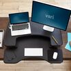 Overhead view of the VariDesk Pro Plus 36 Black sit-stand desk converter lowered on a wooden desk