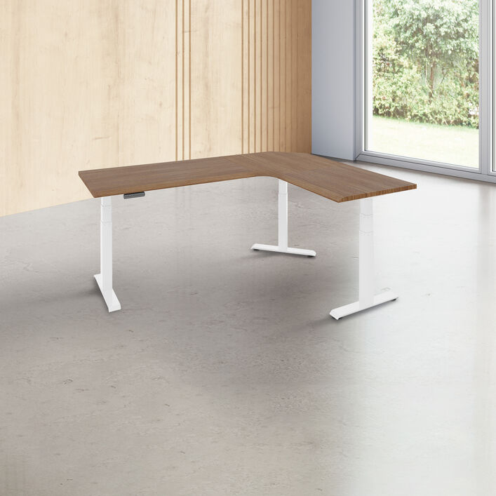 l shape desk with a walnut finish desk top with white legs in a open office image number 0