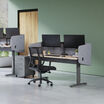 desk surround attached to a standing desk in a lowered position