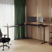 raised l shape desk in black in an at home office setting 