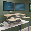 varidesk pro plus 36 light wood sit-stand desk converter in raised position at home office