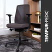 Dark Gray ergonomic Tempur-Pedic office chair from Vari with mesh back and adjustable armrests, shown in a modern office setting with wood shelving and decorative accents