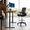 Electric Standing Desk 60 by 24 in raised position in office setting