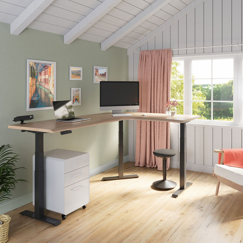 light wood finish l shape electric standing desk in a raised position in the corner of a workspace image number null