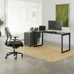 black top and black leg table in an open office